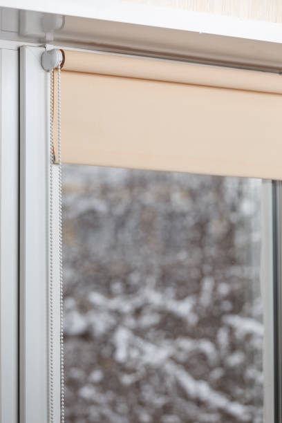 istock Beige blackout roller blind on the window 935274028