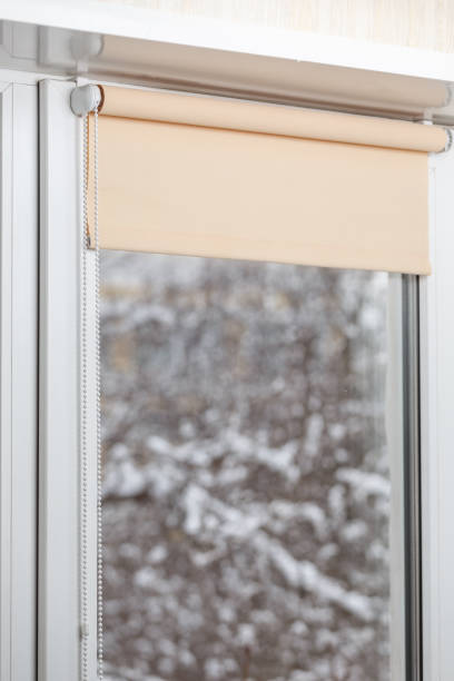 istock Beige blackout roller blind on the window 935274290