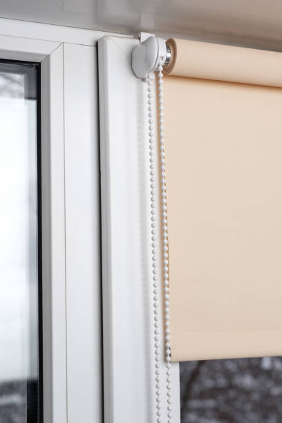 istock Beige blackout roller blind on the window 935274350
