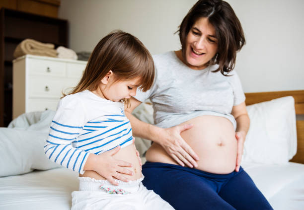 istock Pregnant mom spending time together with her daughter 935274466