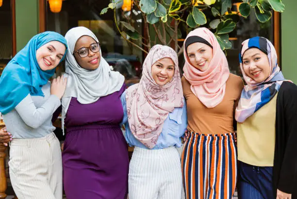 Group of islamic friends arms around and smiling together