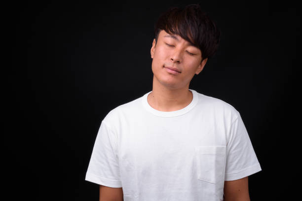 istock Young Japanese Man With Eyes Closed 935278608