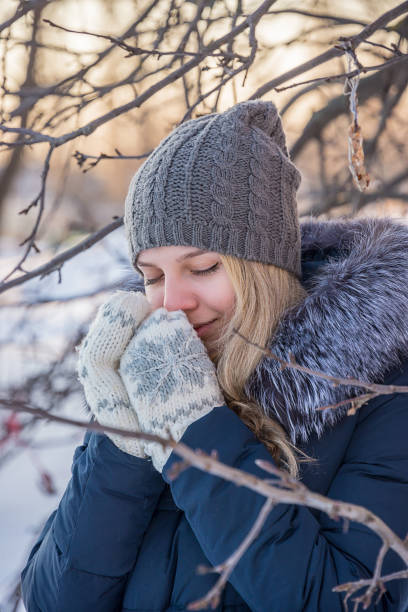 istock girl warms her hands in mittens 935281940