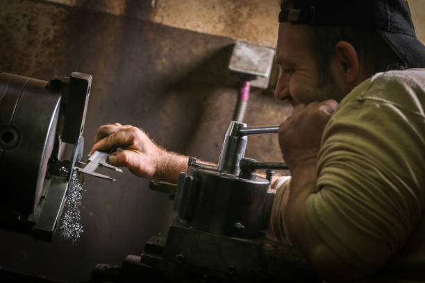 istock Worker professionally measuring the shaped material on lathe 935284802
