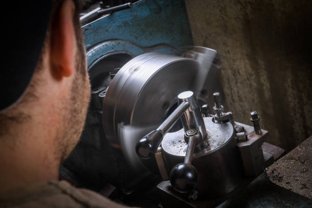 istock Metal worker shaping metal on lathe 935285372