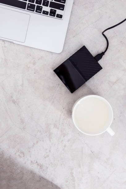 istock External hard drive disk connected to the laptop 935285978