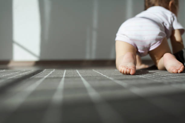 baby girl crawling on floor