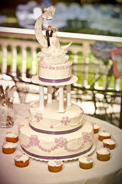 Radiant Classic Wedding Cake with Cupcakes to Match stock photo