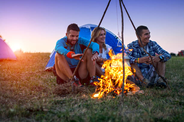 istock Three friends camping on mountain at sunset 935293948