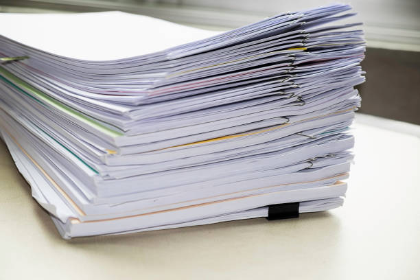 istock Pile of unfinished documents on office desk, Stack of business paper 935294106