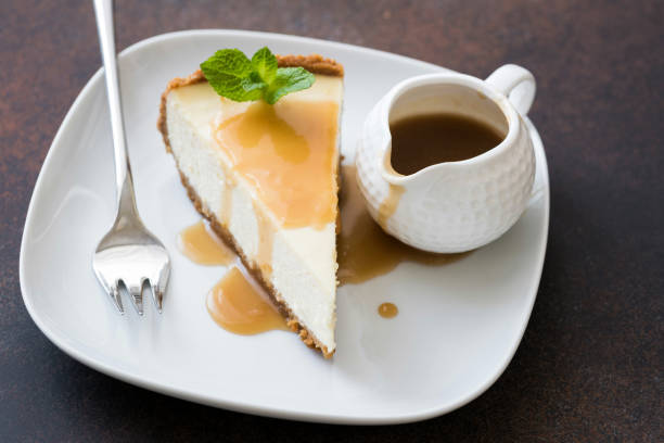 istock Cheesecake with caramel sauce on white plate 935294560