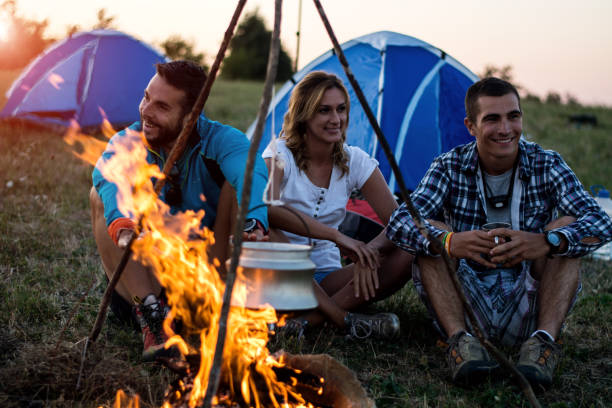 istock Three friends camping on mountain at sunset 935294574