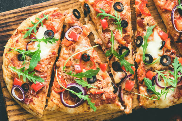 istock Homemade flatbread pizza garnished with fresh arugula 935295732