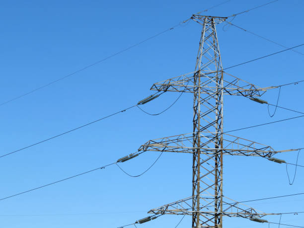 istock High-voltage support of a power line against the clear blue sky 935296956