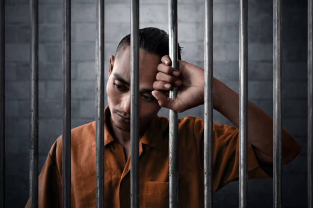 Man In Prison Stock Photo - Download Image Now - Prisoner, Prison, Sadness - iStock