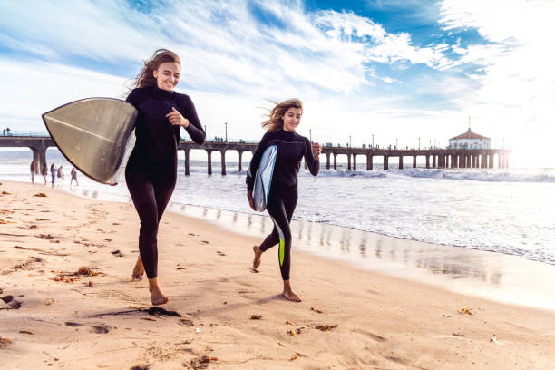 ロサンゼルス ・ カリフォルニア州でサーフィンに行くの女性の友人 - santa monica surfing beach city of los angeles ストックフォトと画像
