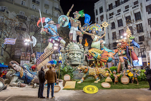 General view of a Falla during Las Fallas Festival on March 16, 2018 in Valencia, Spain. The Fallas is Valencias most international festival, which runs from March 15 until March 19 and celebrates the arrival of spring with fireworks, fiestas and bonfires made by large puppets named Ninots. During the months preceding this unique festivity, a lot of hard work and dedication is put into preparing the monumental and ephemeral cardboard statues that will be devoured by the flames. The festival has been designated as a UNESCO Intangible Cultural Heritage of Humanity since 2017. The theme of this falla is about the aztecas. People look the falla.