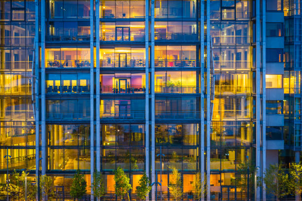 istock Modern business office building windows illuminated at dusk Oslo Norway 935308754