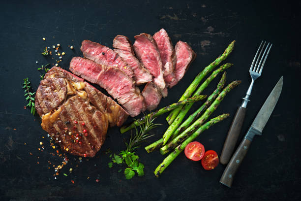 istock Roasted rib eye steak with green asparagus 935316618