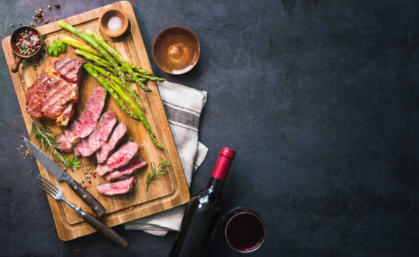 istock Roasted rib eye steak with green asparagus and wine 935316644