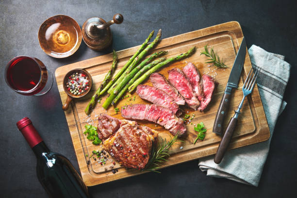 istock Roasted rib eye steak with green asparagus and wine 935316672