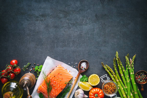 istock Fresh salmon fillet with aromatic herbs, spices and vegetables 935316712