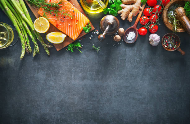 istock Fresh salmon fillet with aromatic herbs, spices and vegetables 935316724