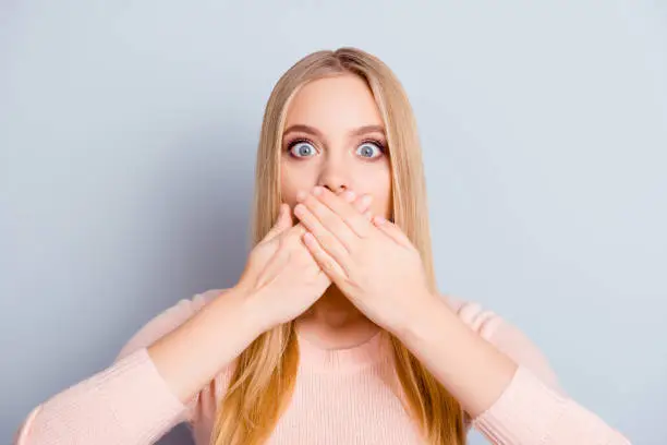 Discuss palm privacy chatter communication person lifestyle message concept. Close up portrait of charming cute innocent amazed wondered manager covering mouth with hands isolated on gray background