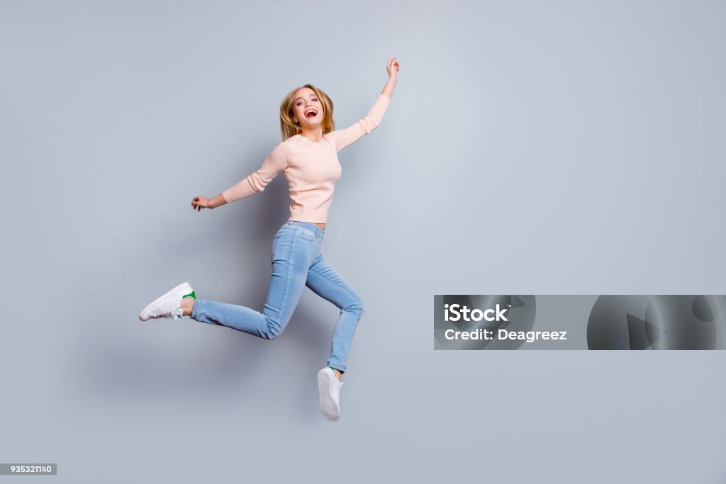 Job employment shoes legs laughter person fan concept. Full-length full-size view of laughing feeling good mood pretty businesswoman dressed in jeans denim sweater outfit isolated on gray background Jumping Stock Photo