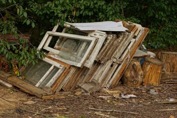 istock Old construction debris from window frames and broken glass on the street 935321166