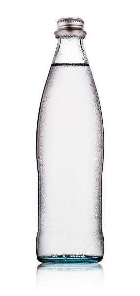 Glass bottle of water with drops isolated on white background