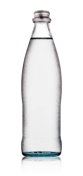 Glass bottle of water with drops Glass bottle of water with drops isolated on white background tonic water stock pictures, royalty-free photos & images