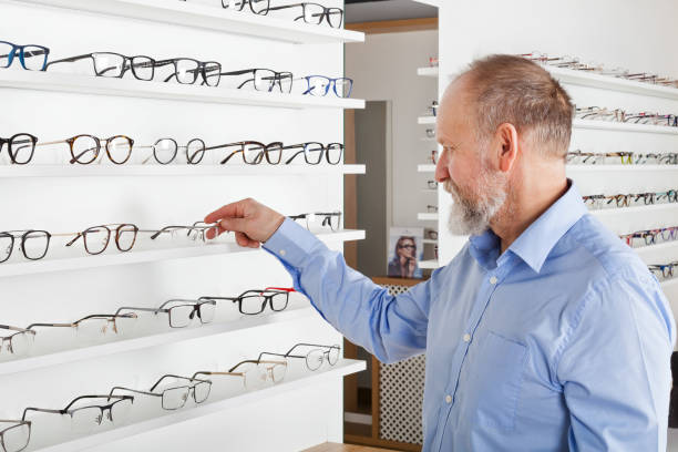 istock Elderly man in optics store 935325116