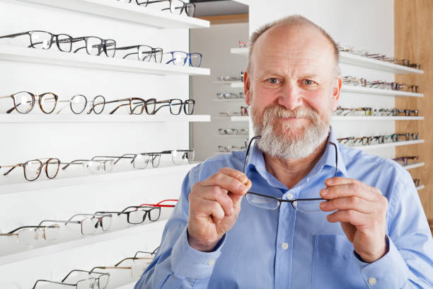 istock Elderly man in optics store 935325318