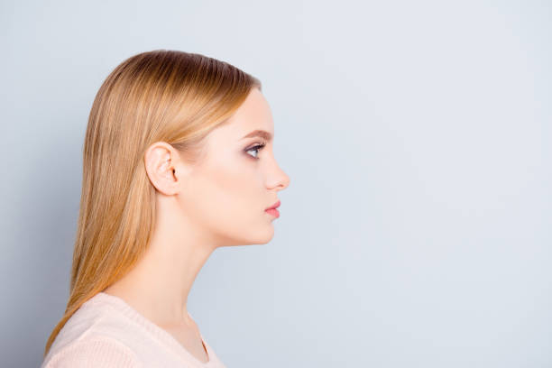 istock Half-faced profile side view close up portrait of serious confident focused concentrated thinking pondering pretty cute lovely manager wearing beige blouse isolated on gray background copyspace 935331092