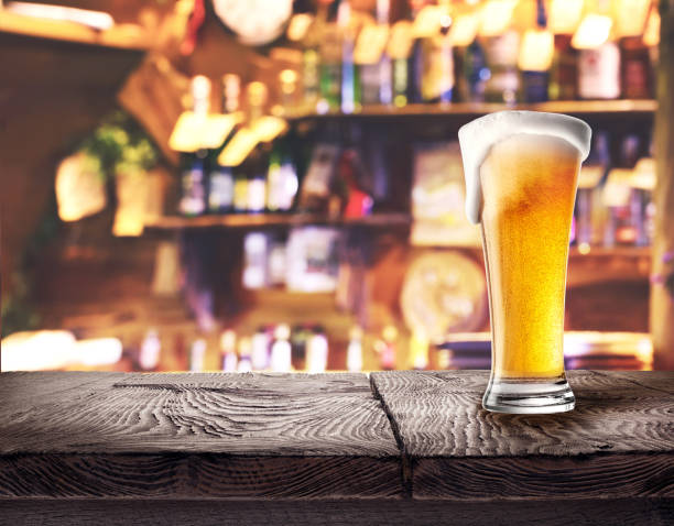 istock Glass of light beer on wooden board 935333584