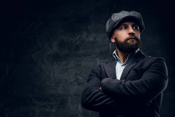 istock Bearded male with crossed arms dressed in a tweed cap. 935334768
