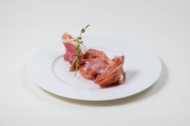 istock Parma Ham on a white plate on a white background 935343344