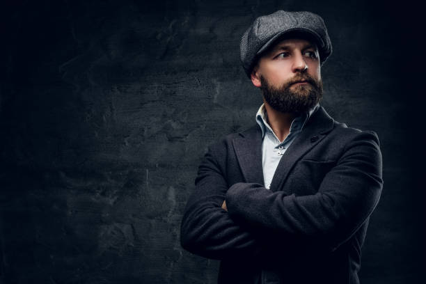 istock Bearded male with crossed arms dressed in a tweed cap. 935345768