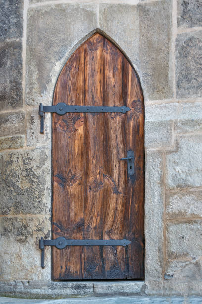 istock Medieval wooden door with iron hinges 935346720