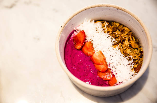 Pink smoothie bowl with coconut and granola