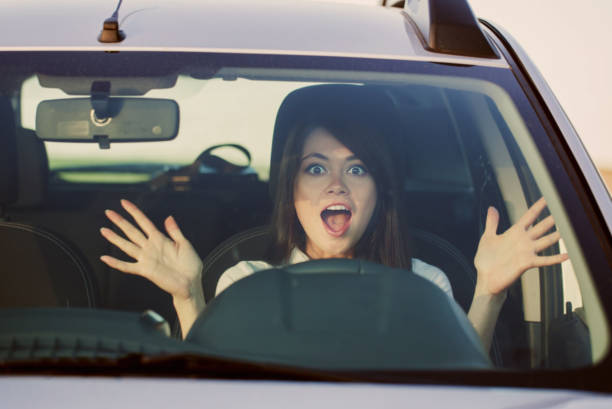 istock scared woman shouts driving the car 935350954