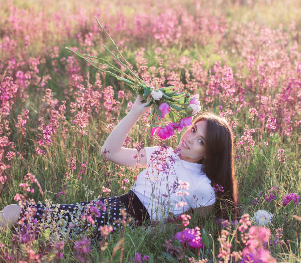 Free Stock Photo of Woman Laying on Ground Surrounded by Pink Flowers ...
