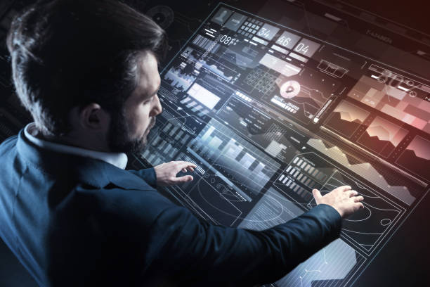 istock Careful specialist putting hands on the transparent screen while working alone 935351232