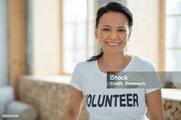 Cheerful Female Volunteer Performing Community Service Stock Photo - Download Image Now