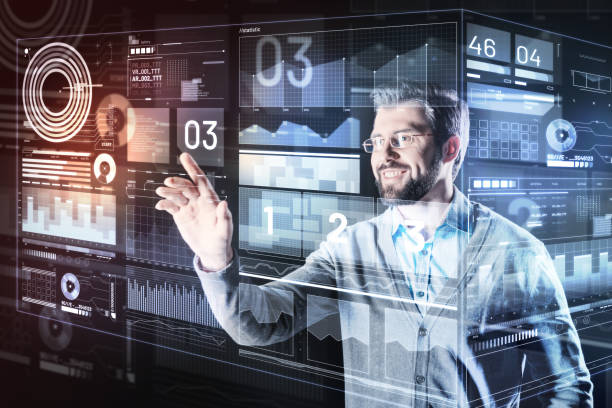 istock Positive man wearing glasses and looking at the transparent screen 935355274