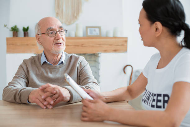 istock Volunteer and focused senior man debating over book 935359532