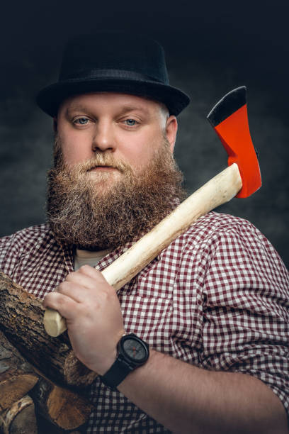 istock Fat bald, bearded man holds an axe. 935360442