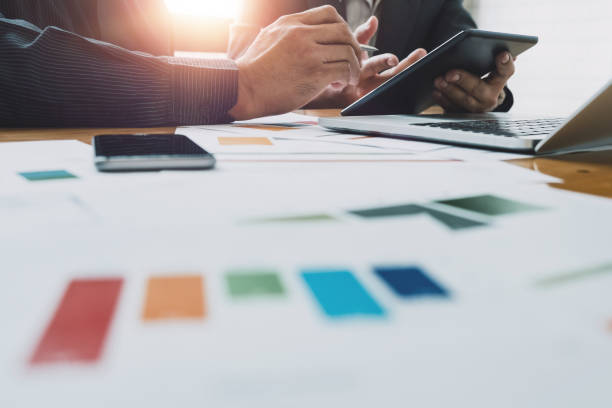 istock Business team two colleagues discussing new plan financial graph data document  with laptop and digital tablet - Business meeting concept 935363356