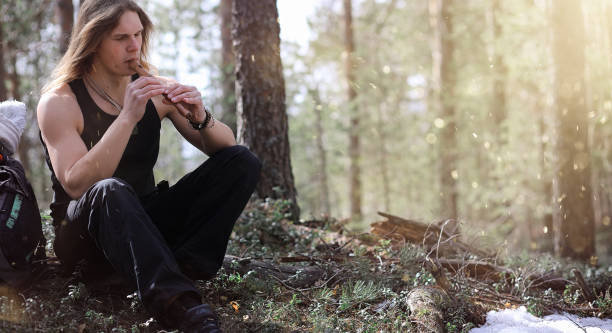 istock A musician with a tool in nature. A man is playing a flute in a 935366346